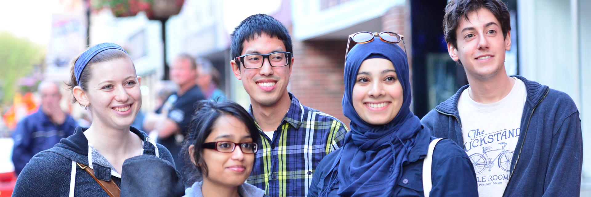 A group of students exploring the city, smiling at the camera.