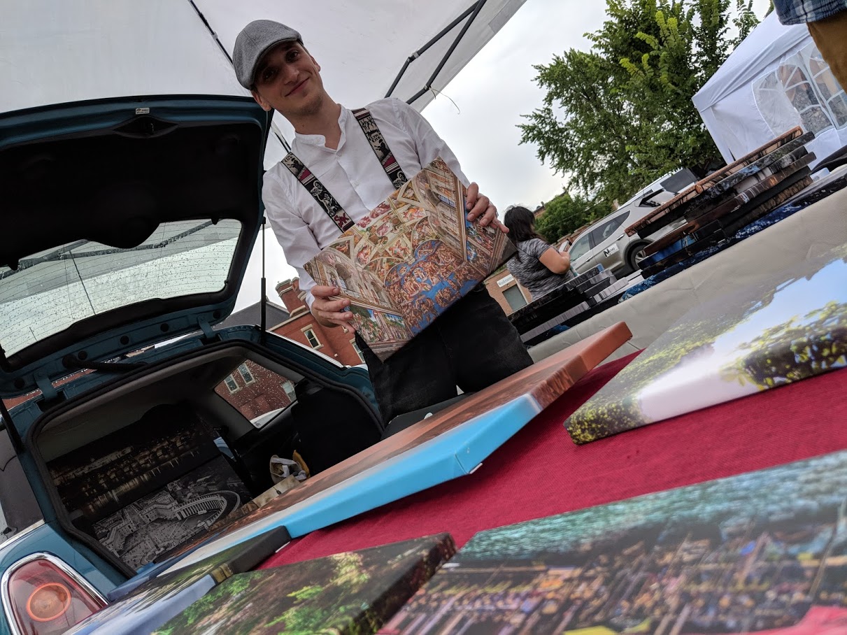 Jeremy Wolting, Wolting Photography, showing some of his prints he had for sale at the Strip Mall