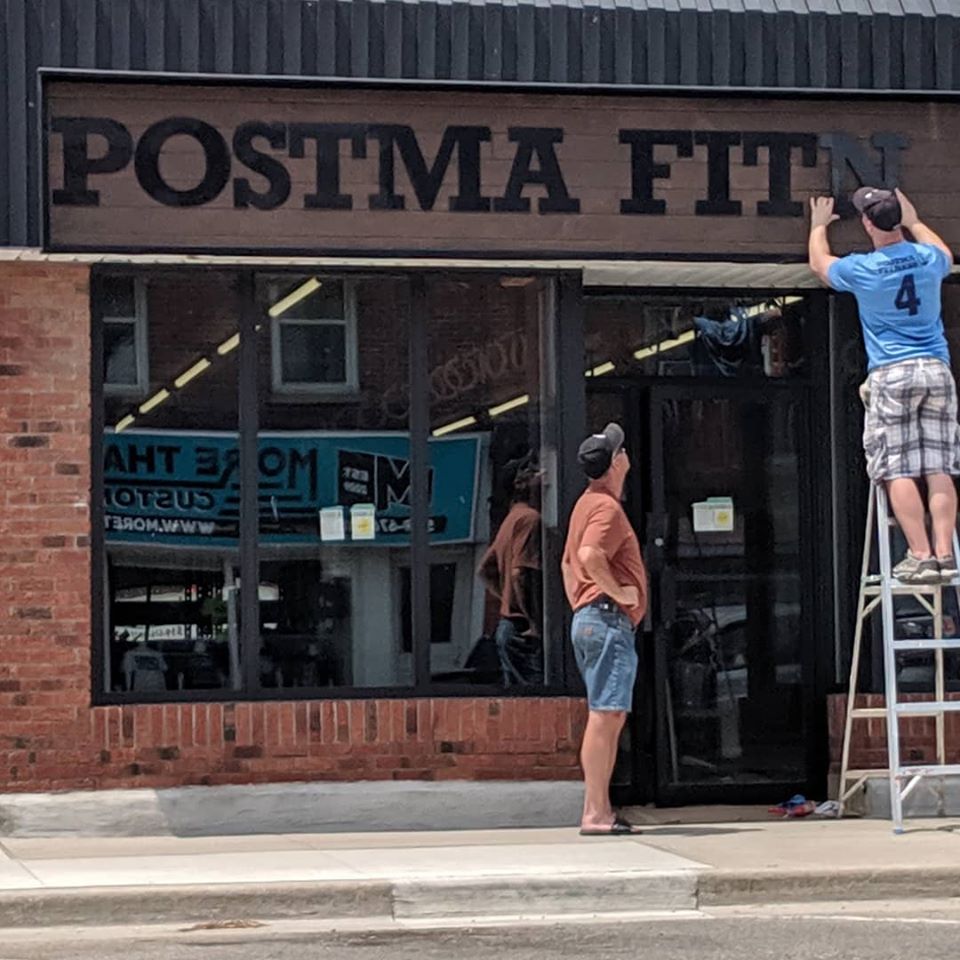 Installing the new sign letters on Postma Fitness in Downtown Blenheim on a Sunday afternoon in July, 2019
