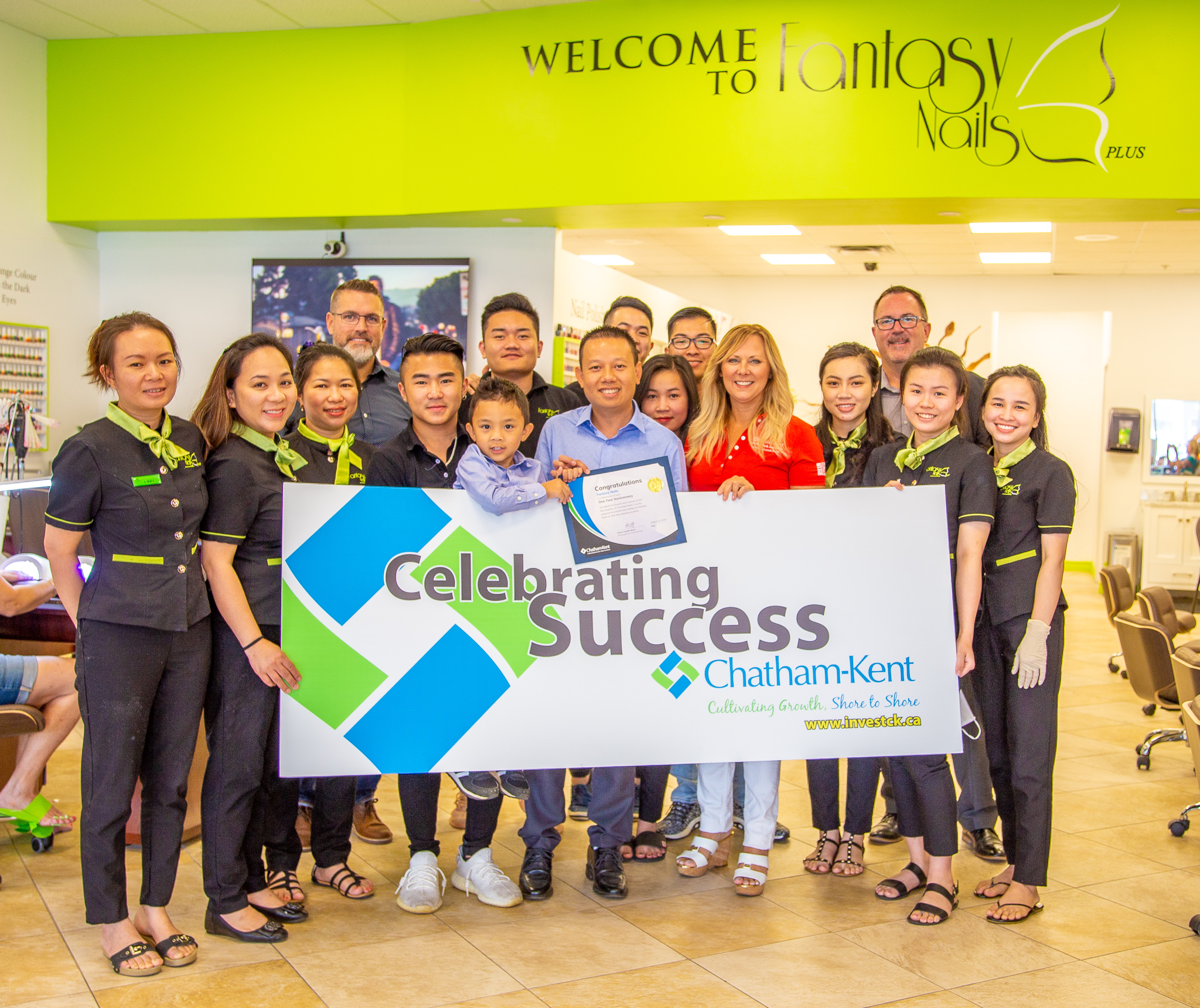 Minh Dinh (centre), President of Fantasy Nails Plus, along with family, staff, the Chatham-Kent Economic Development team, and M