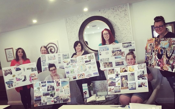 Participants at a vision board session use images to focus on their goals