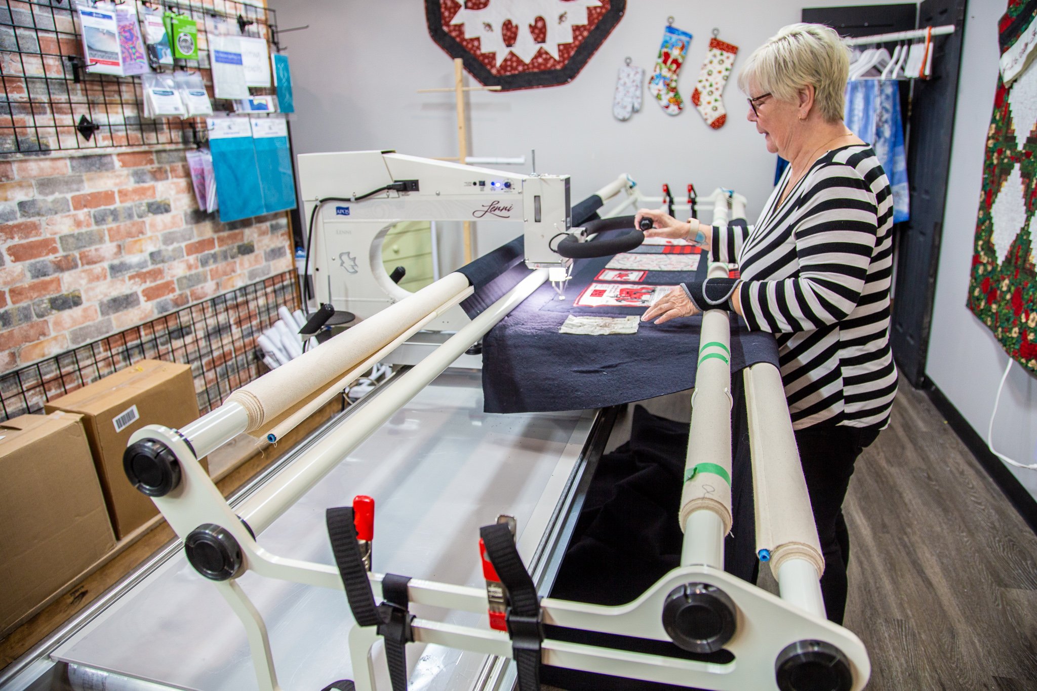 Linda Mifflin, Owner of Put It Together Quilt Shoppe, using the massive 12 foot deep longarm quilting machine