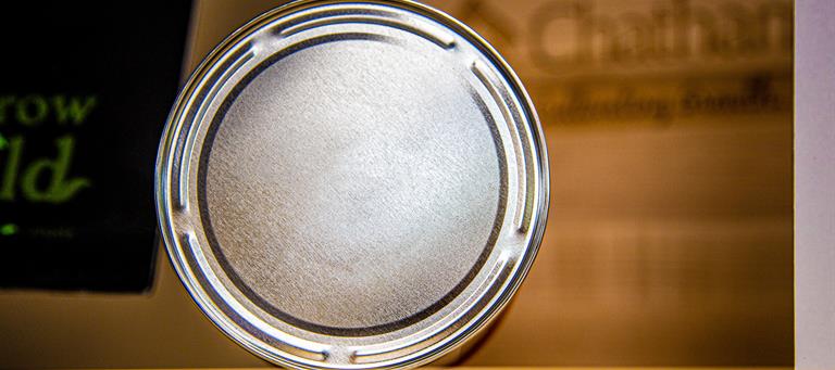 Five interrupted beads on the bottom of the can form a star-like pattern that make it easy to identify this as a can made in CK
