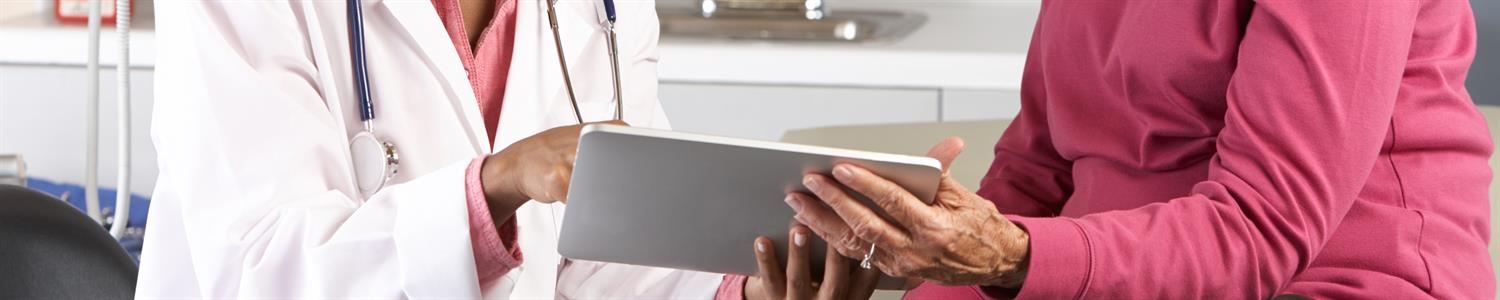 Image of doctor meeting with an elderly woman.