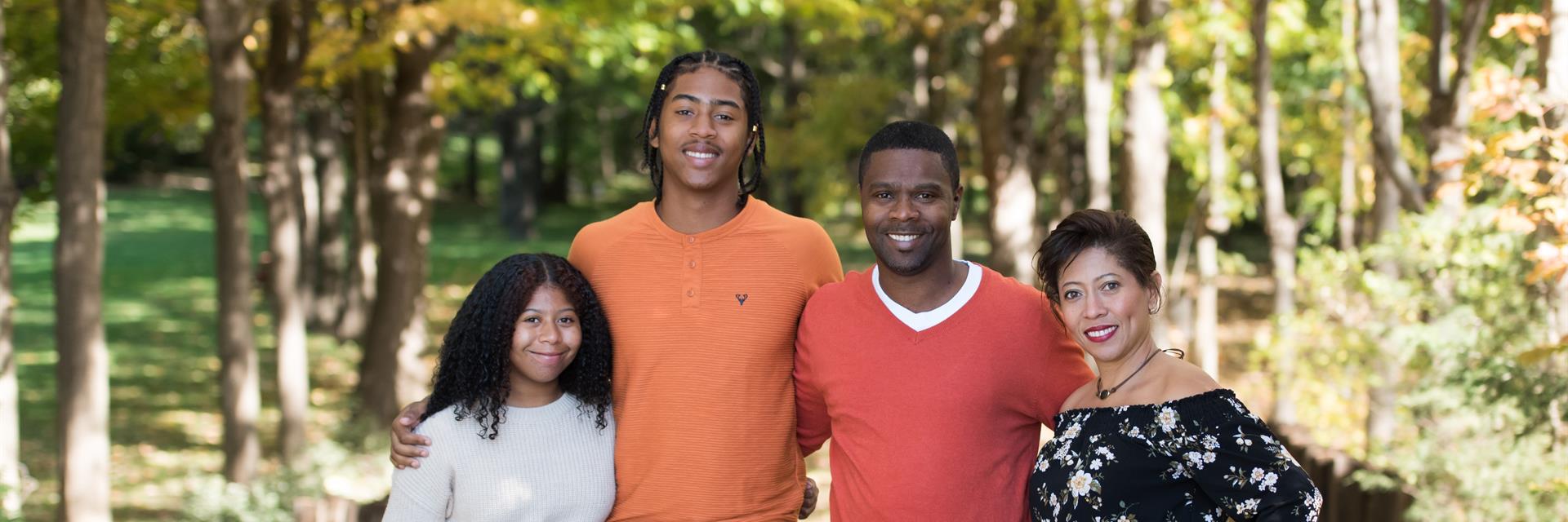 Family standing on a trail.