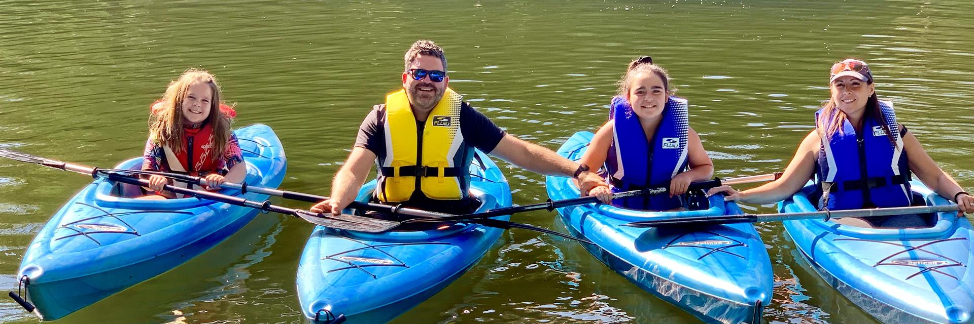 Two people kayaking on an open bay.