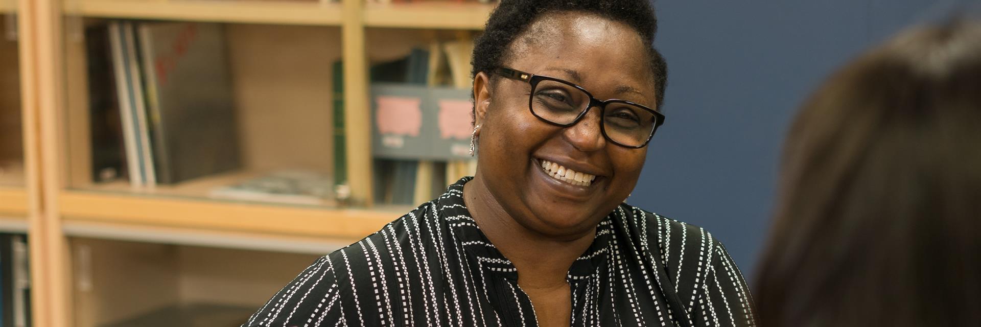 Person laughing in a library.