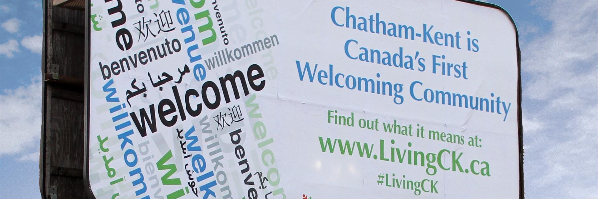 A billboards showing Chatham-Kent is Canada's fist Welcoming Community