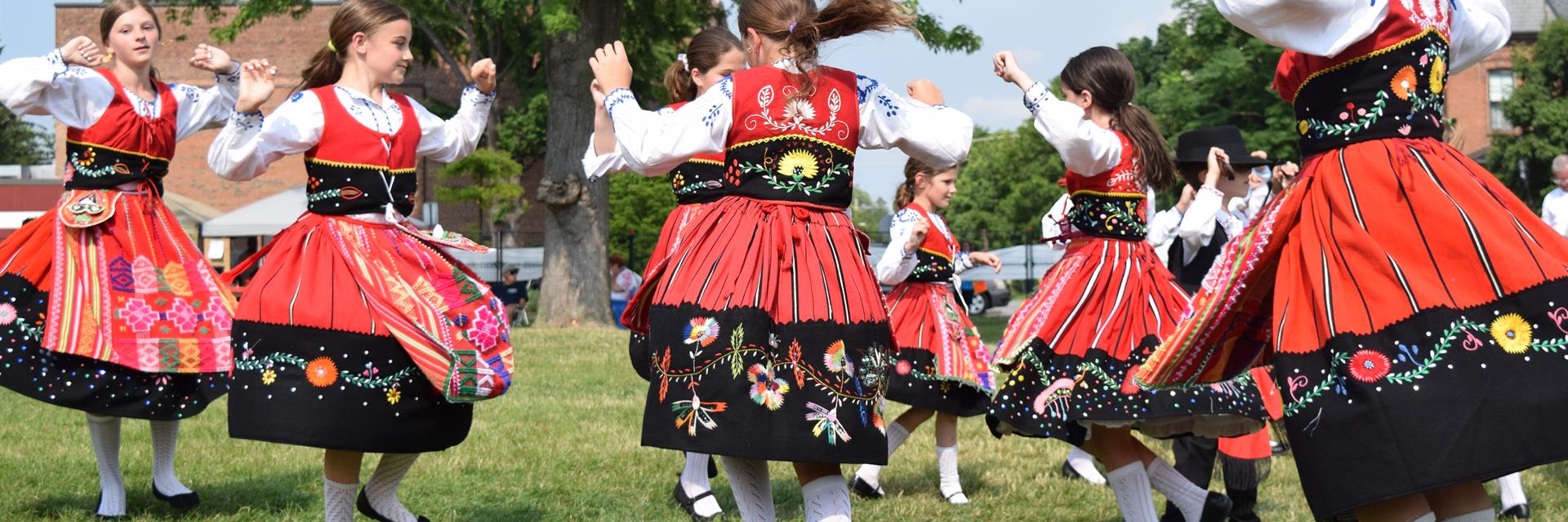 Group of people dance in traditional costumes