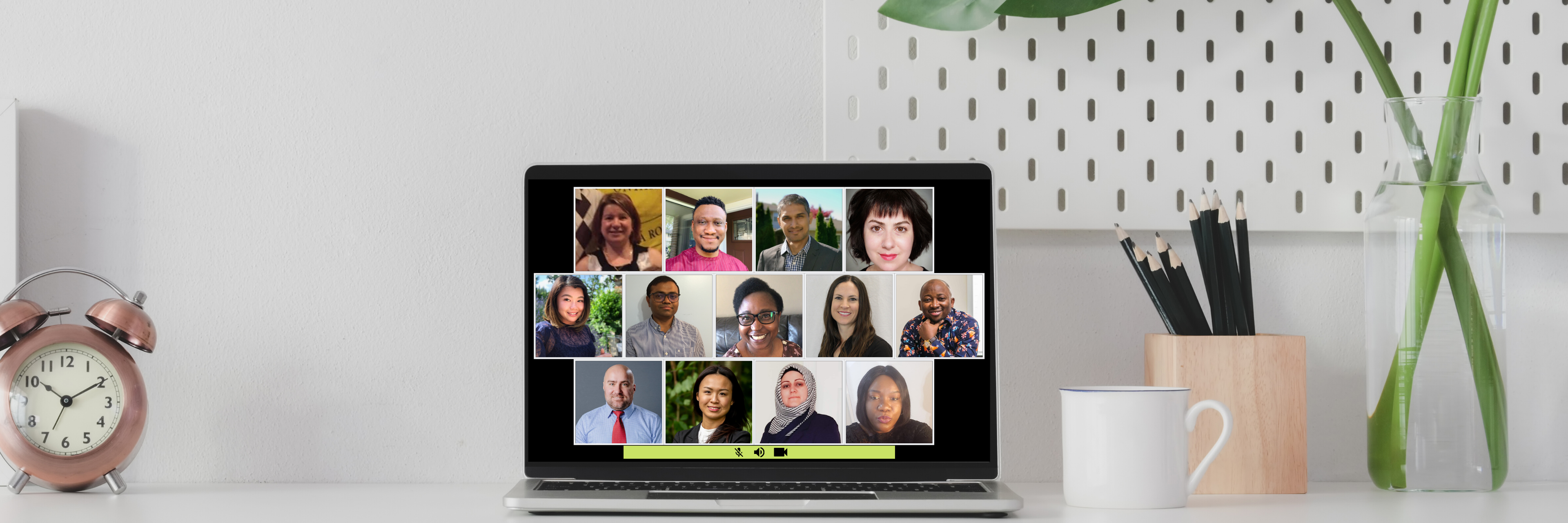 A laptop screen shows a group of people are having an online video meeting