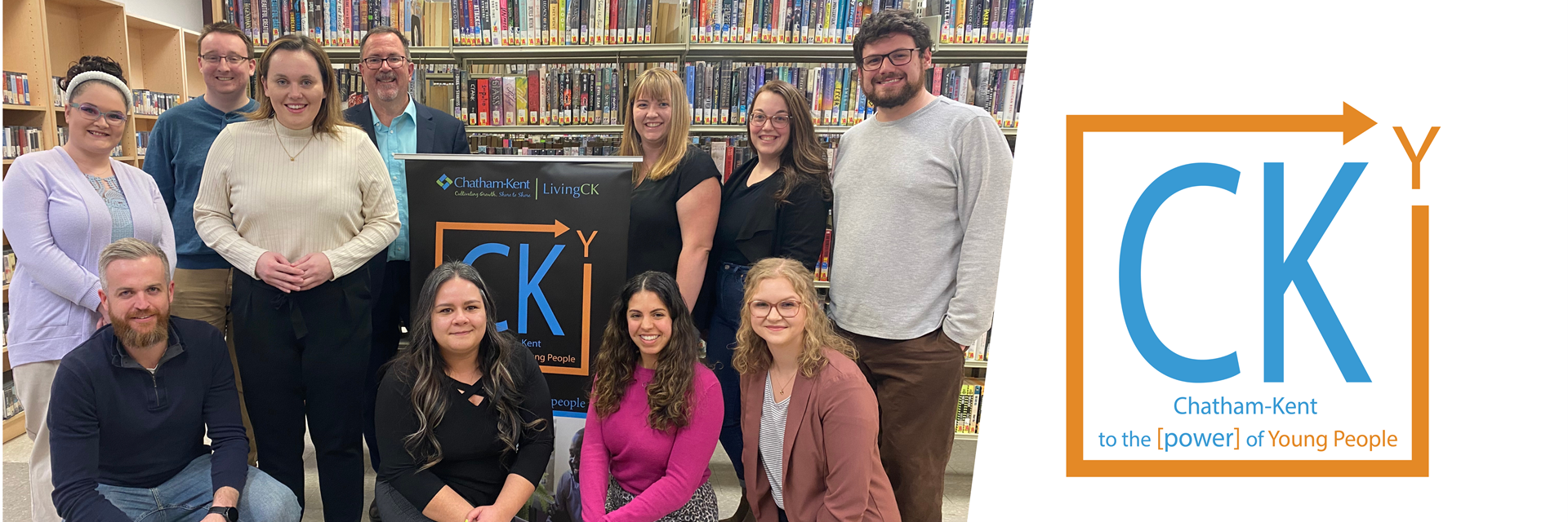 CKY Advisory Group members and Mayor Canniff smiling in a group with a bookshelf behind them.