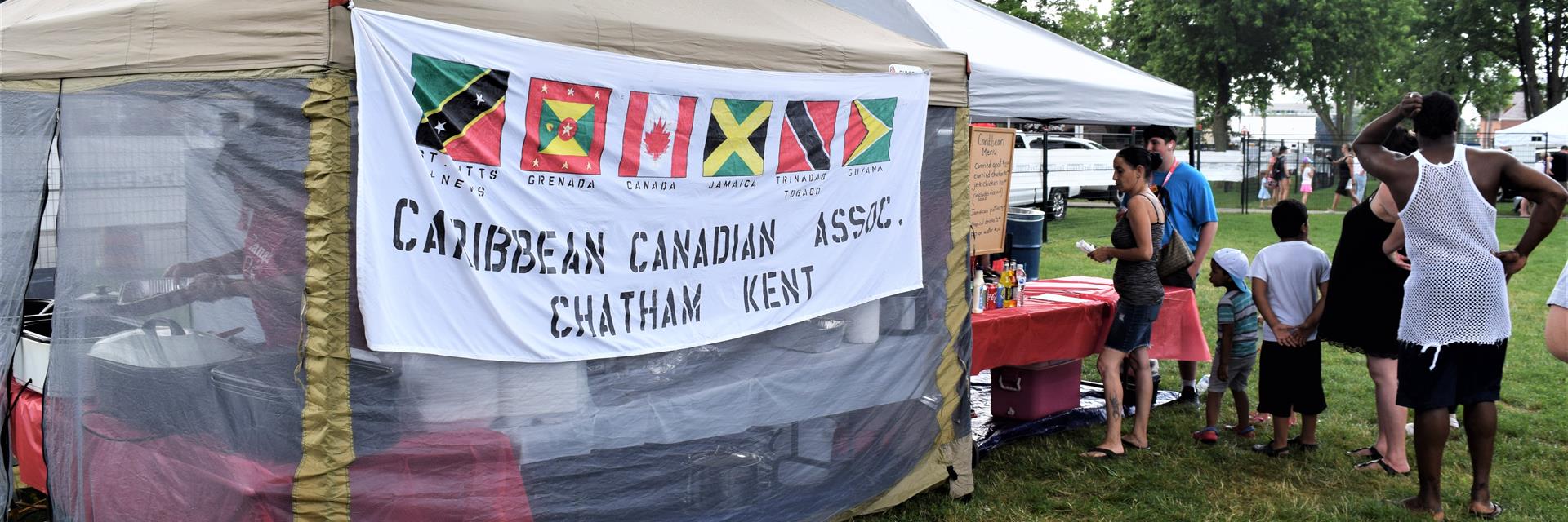 Caribbean Association of Chatham-Kent banner on a food booth.
