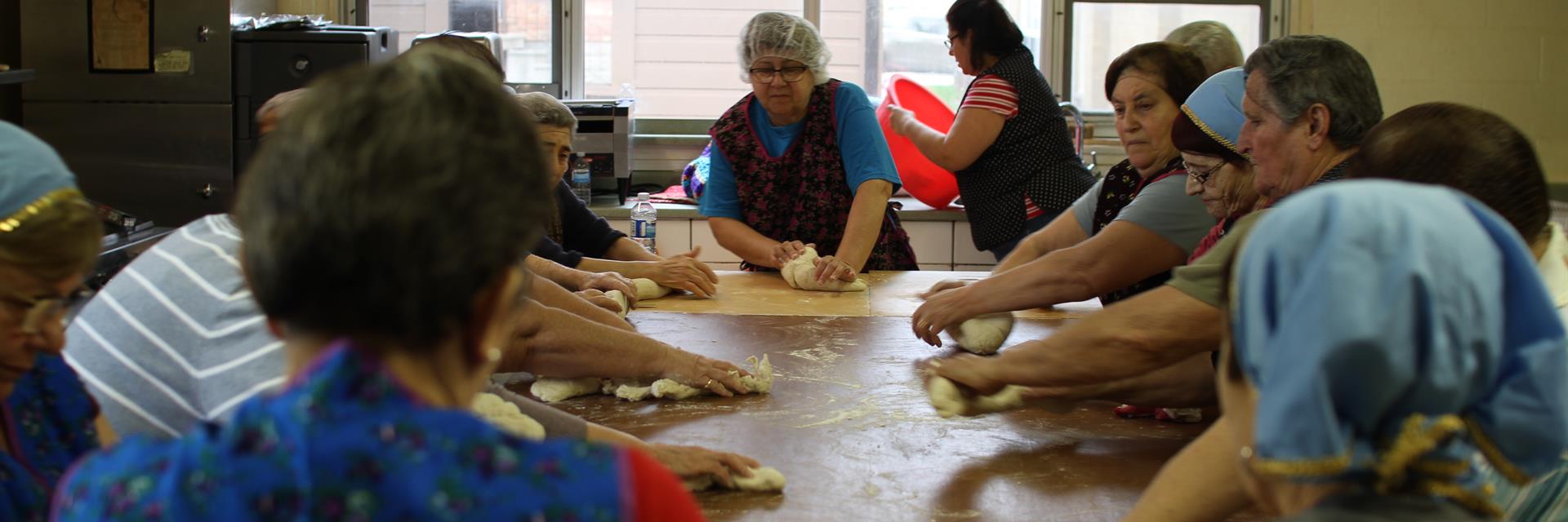 Women kneading bread.