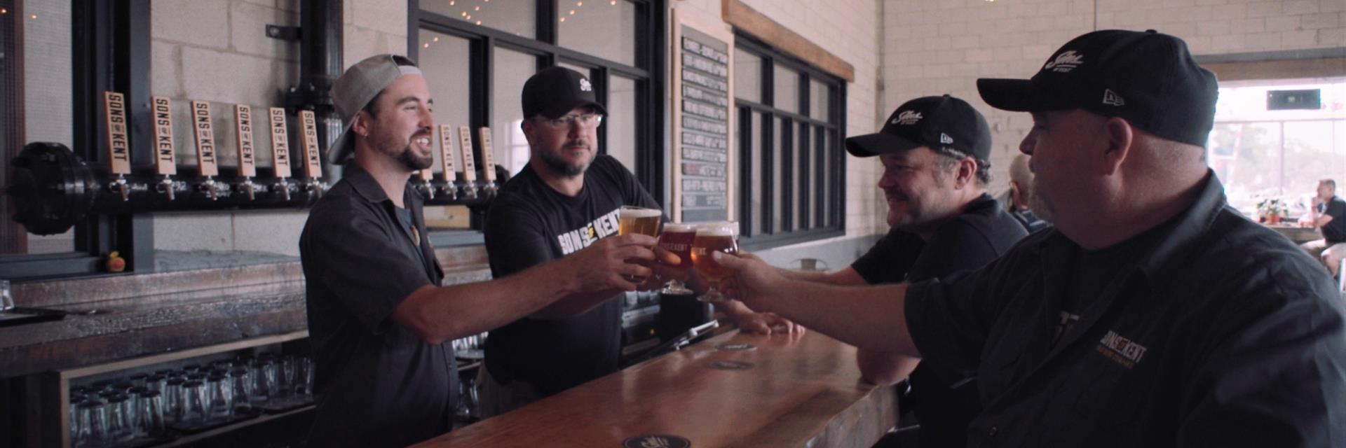 Brewery owners having a drink at their bar.