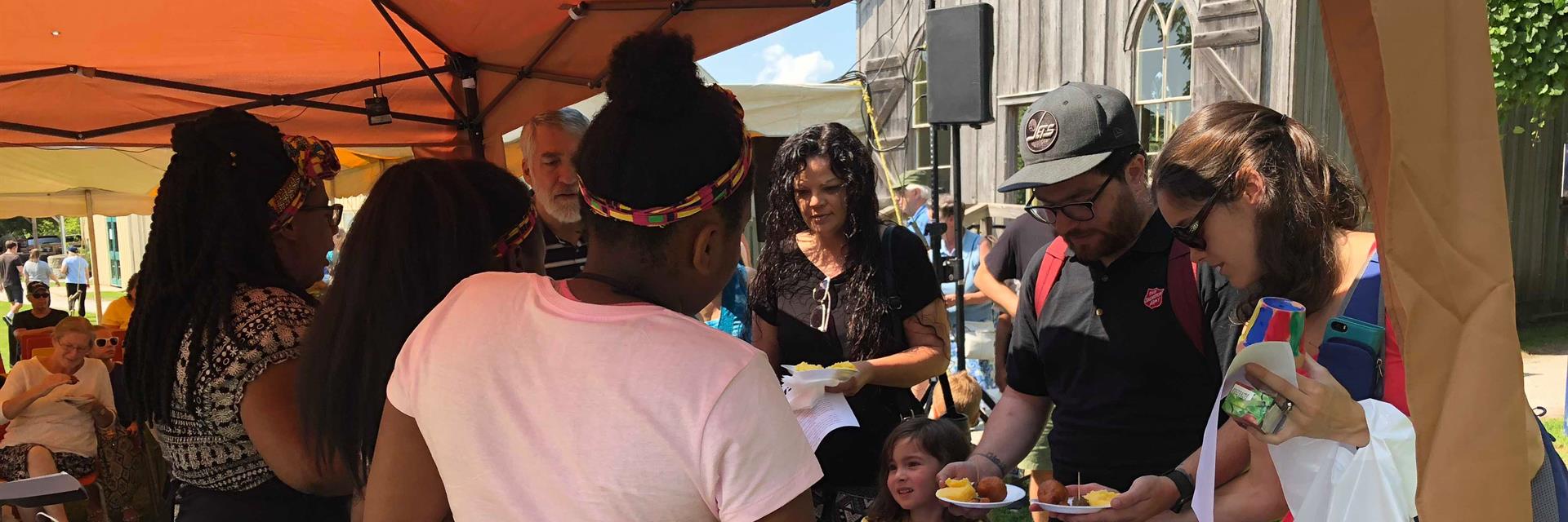 Group of people running a food booth at an event.