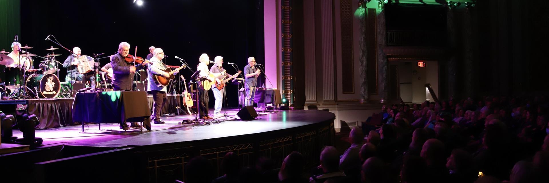 live band playing at a theatre with crowd