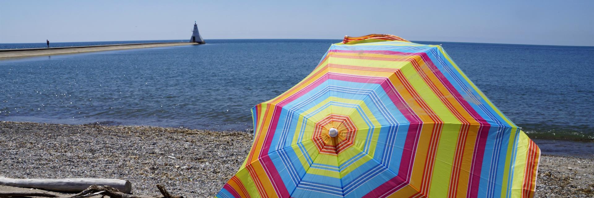 Erieau Light House in Summer with beach umbrella