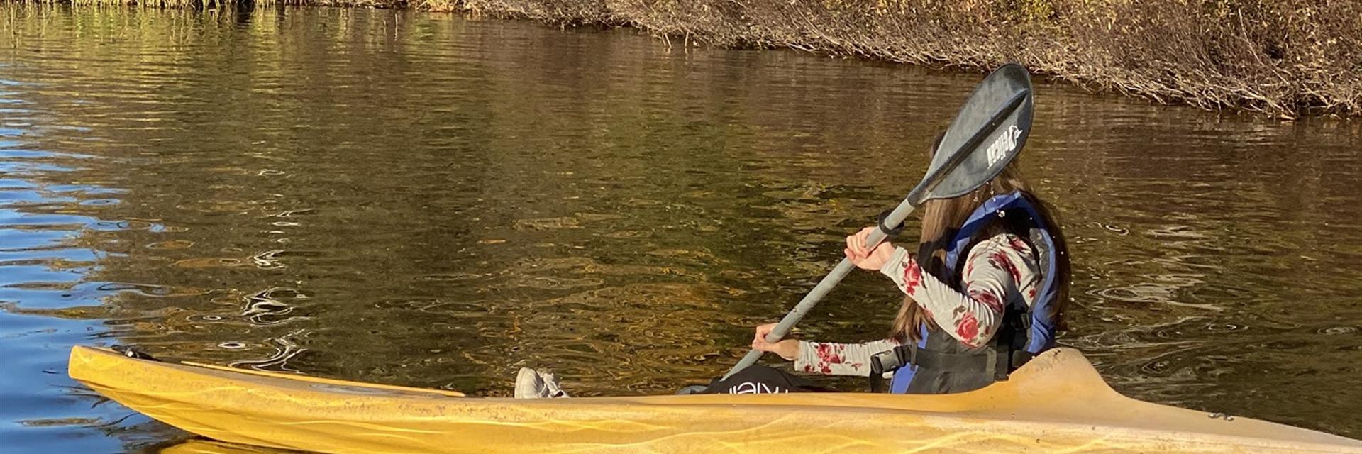 girl kayaking in fall 