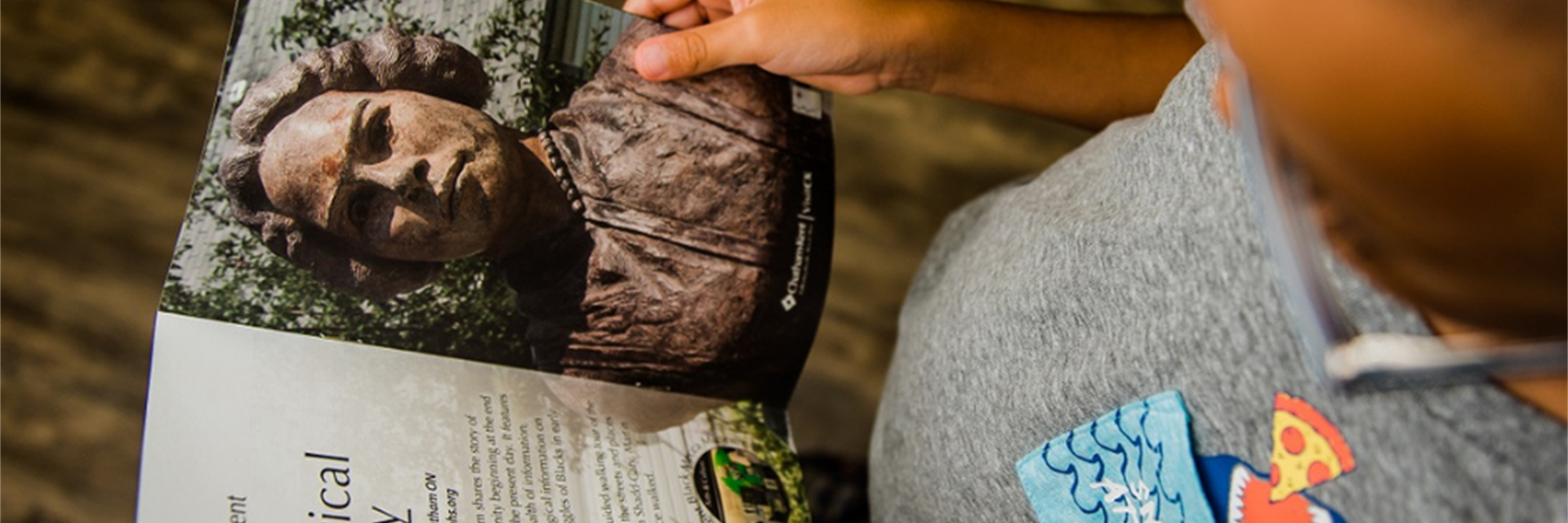 little boy looking at a brochure 