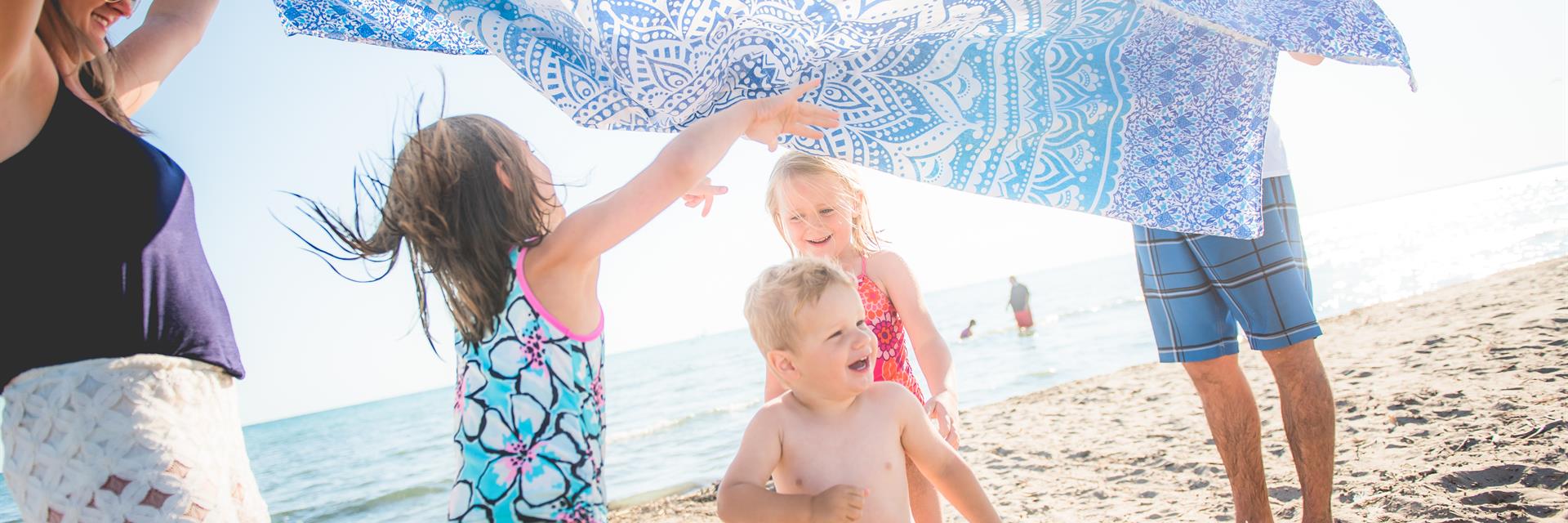 family running on the beach in chatham-kent