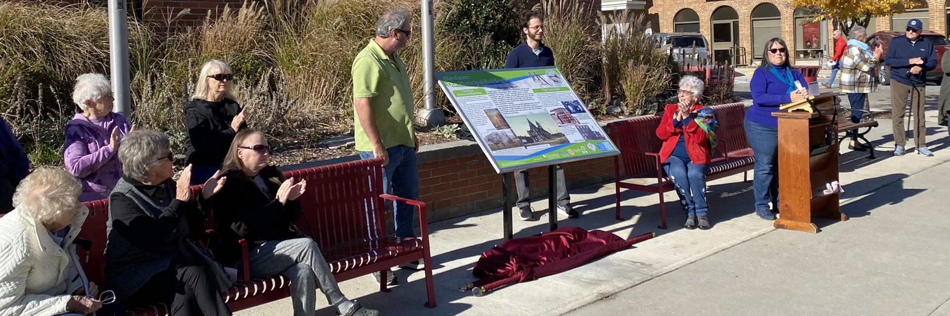 plaque unveiling in a town with people 