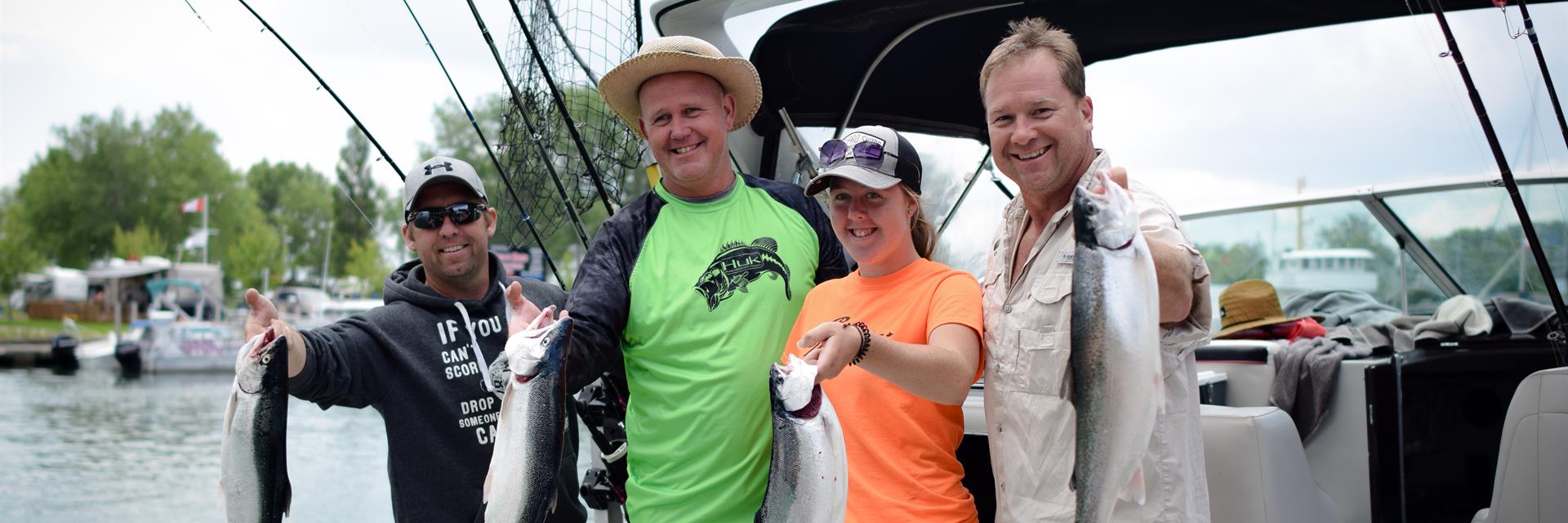 Family holding fish on the back of a charter boat