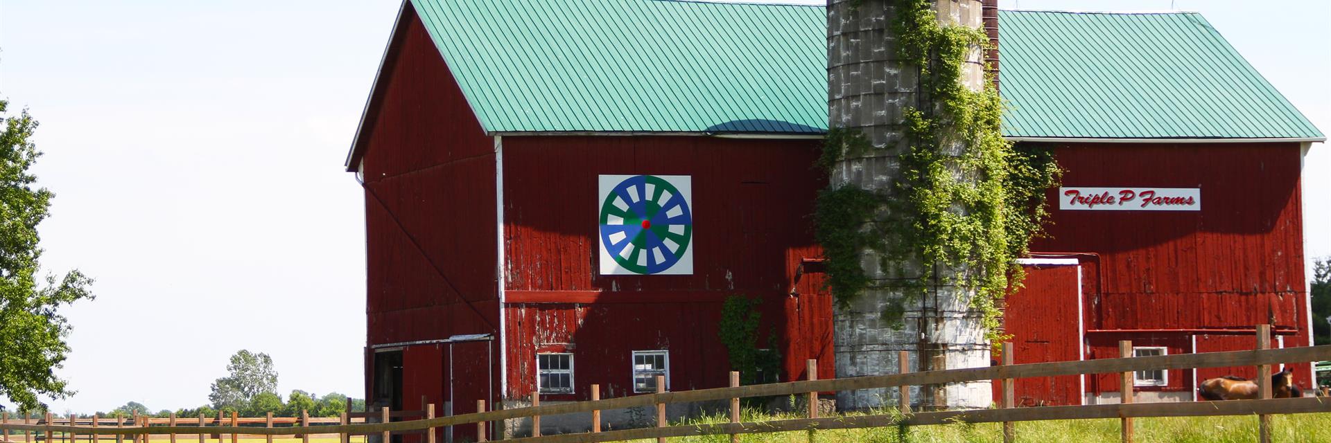 a barn quilt attached to the side of a barn on the thames river barn quilt trail