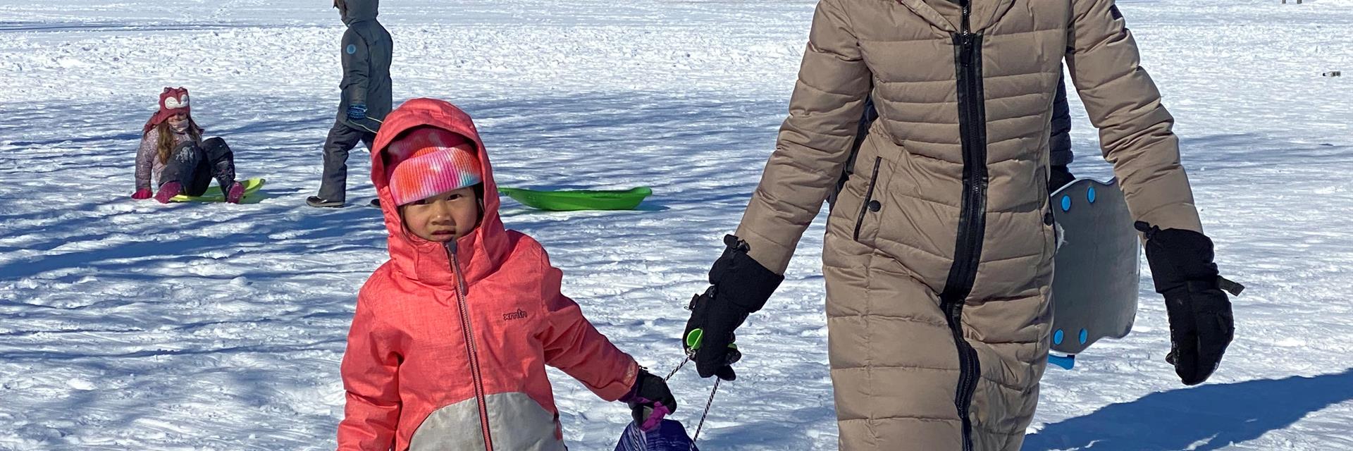 kids with mom and sled in winter