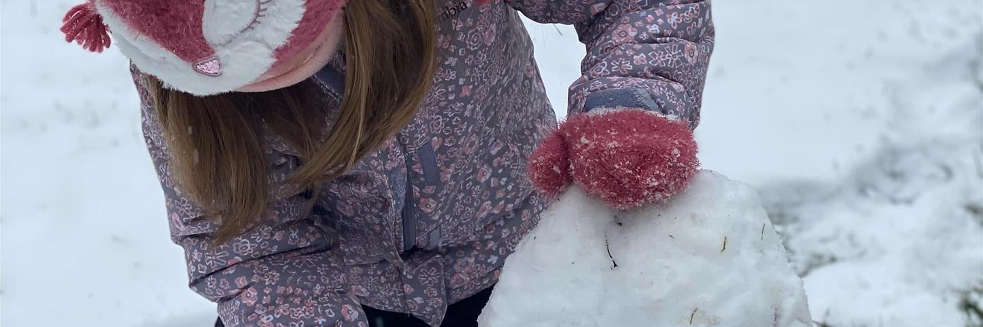 child building a snowman