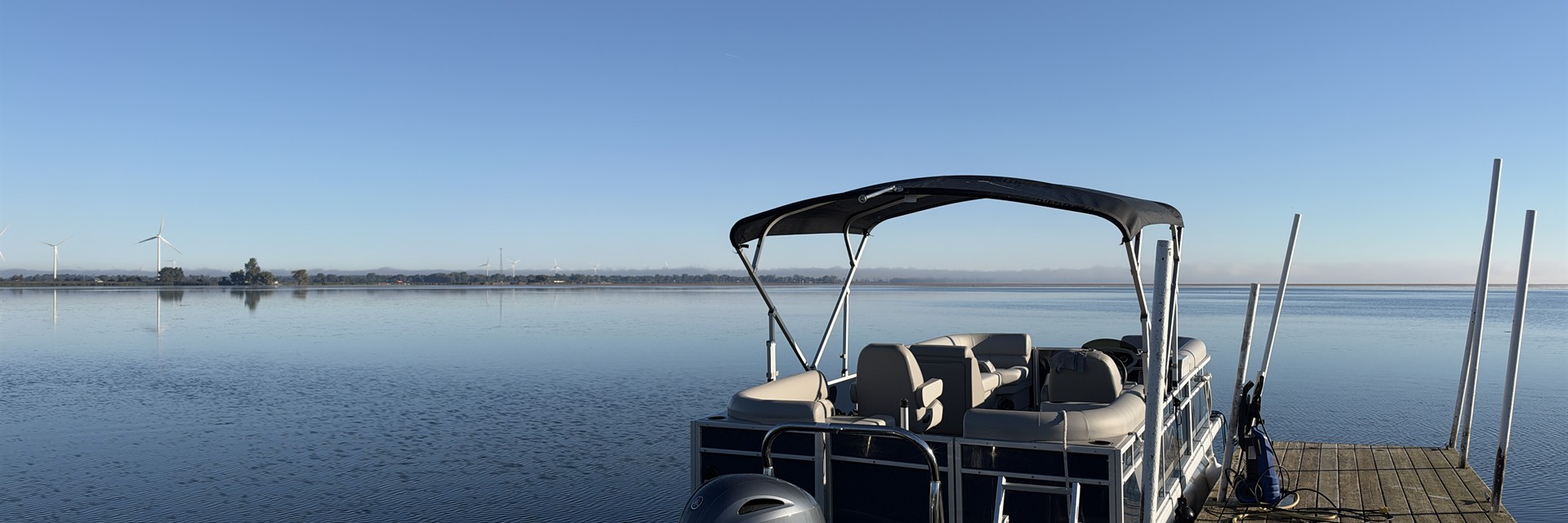 pontoon docked in rondeau bay on sunny day in water