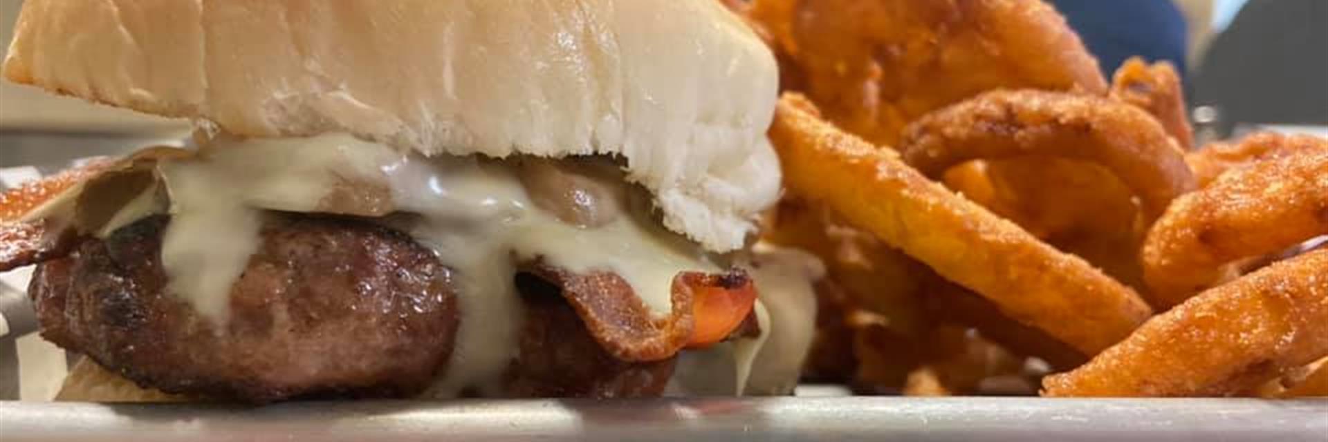 burger with bacon, cheese and onion rings
